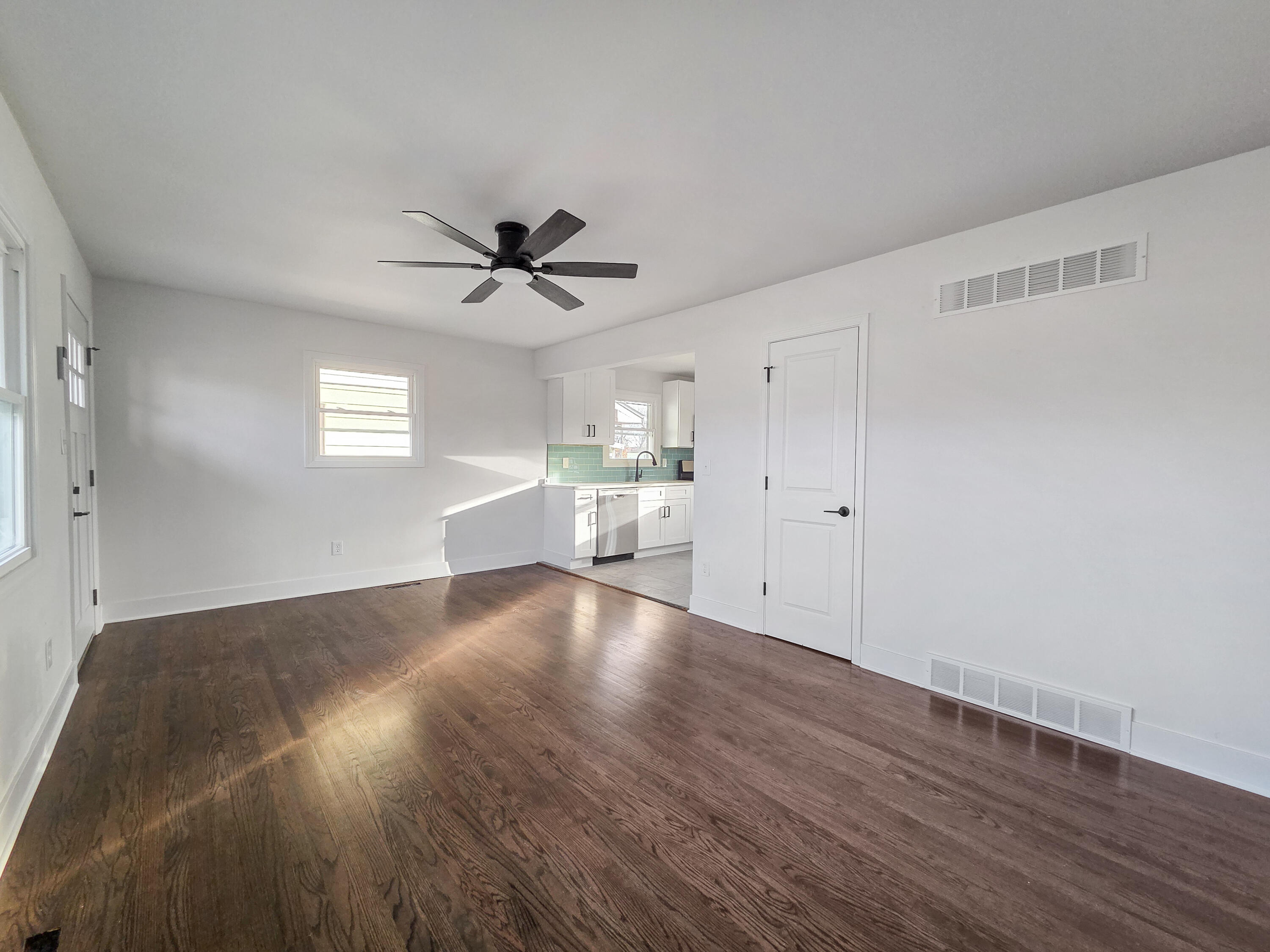 1629 Tennessee Street Gary, IN 46407 - Photo 3 of 26 a view of an empty room with a window and wooden floor