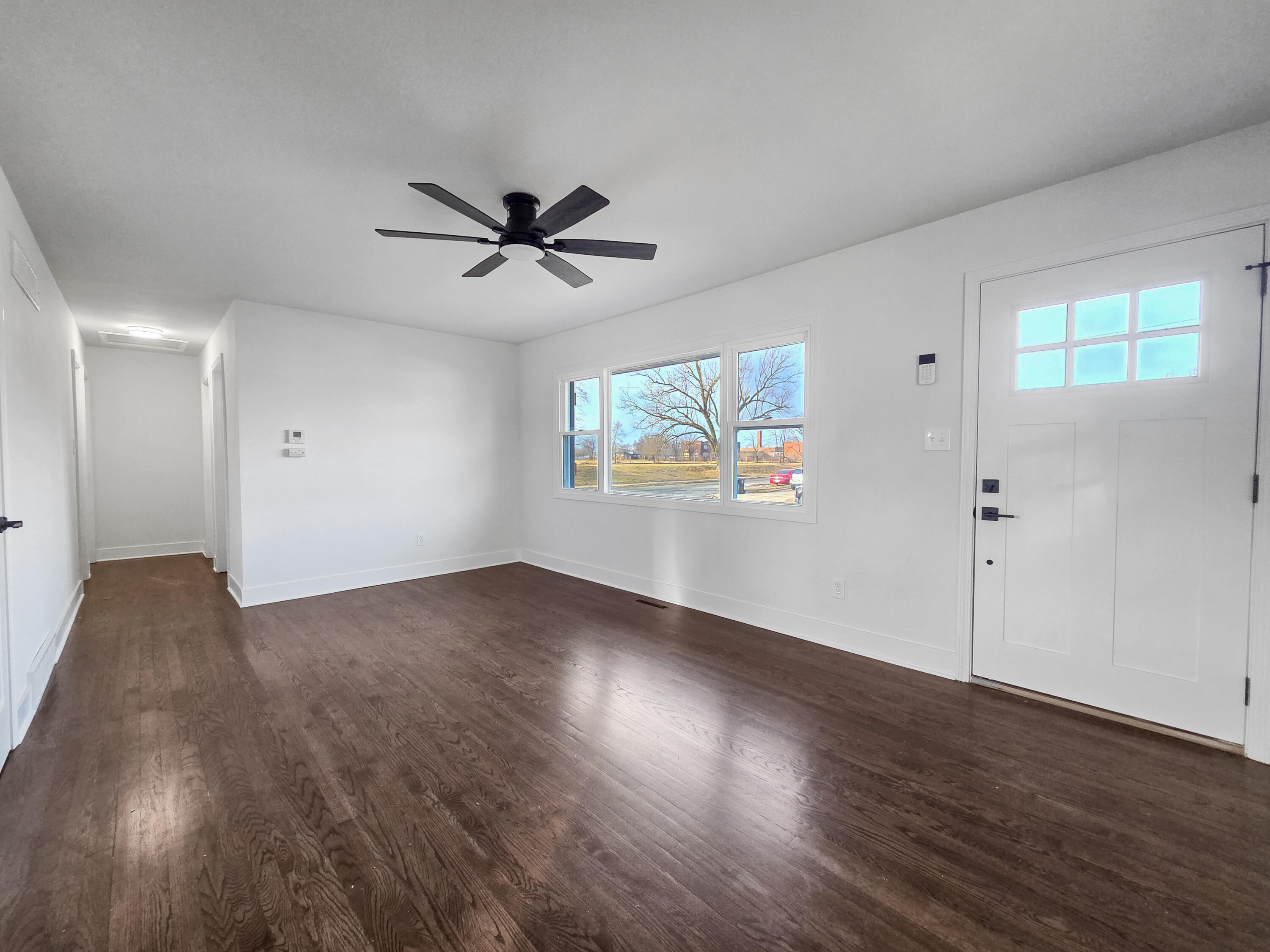 1629 Tennessee Street Gary, IN 46407 - Photo 7 of 26 a view of an empty room with wooden floor and a window