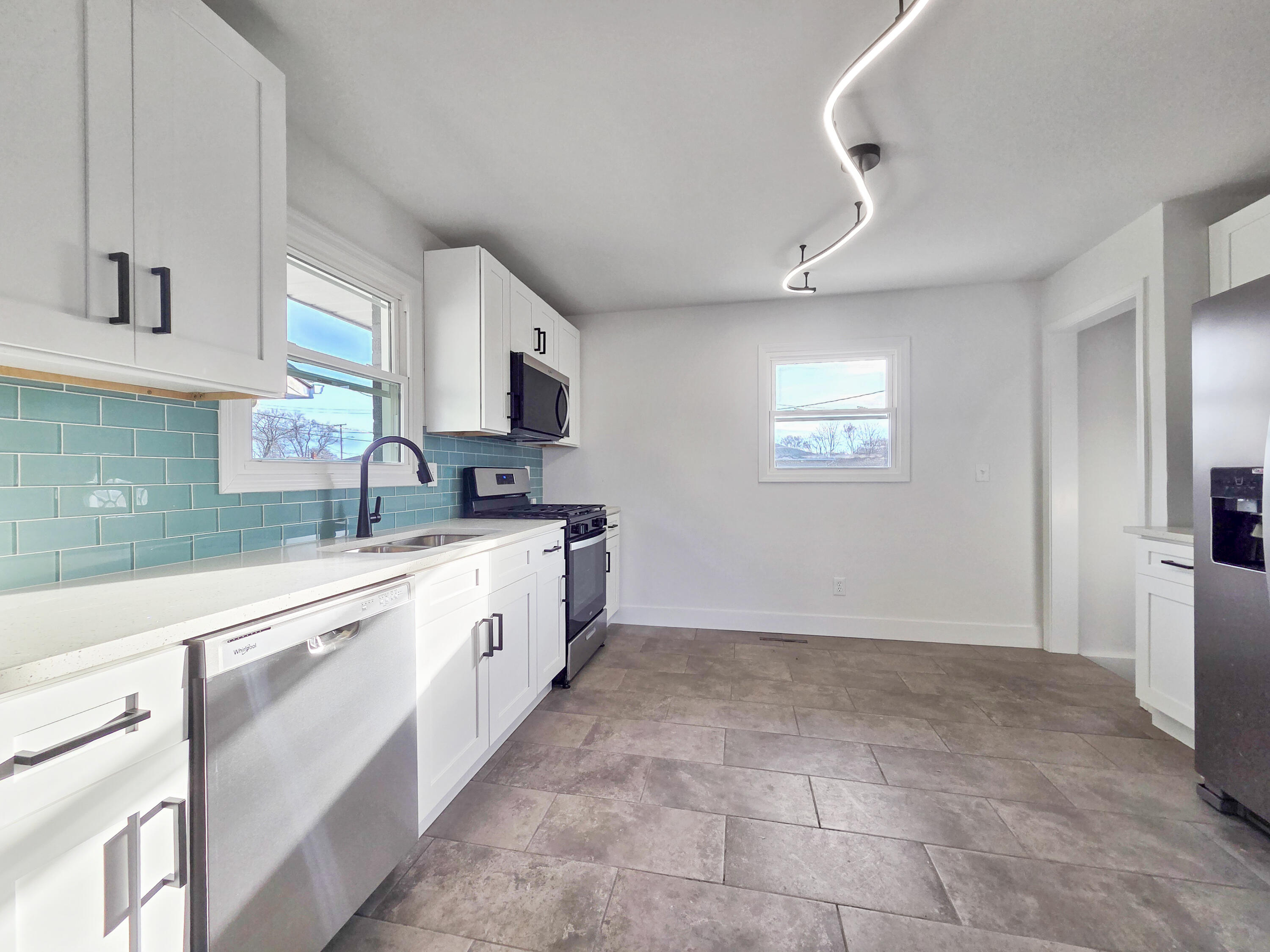 1629 Tennessee Street Gary, IN 46407 - Photo 8 of 26 a large white kitchen with cabinets