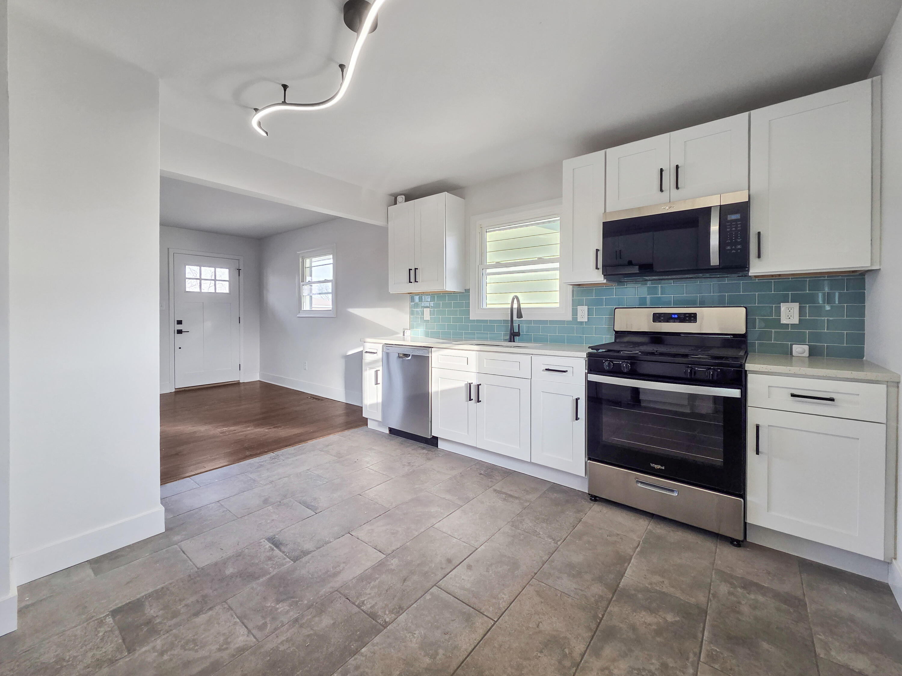 1629 Tennessee Street Gary, IN 46407 - Photo 9 of 26 a kitchen with granite countertop a stove sink and cabinets