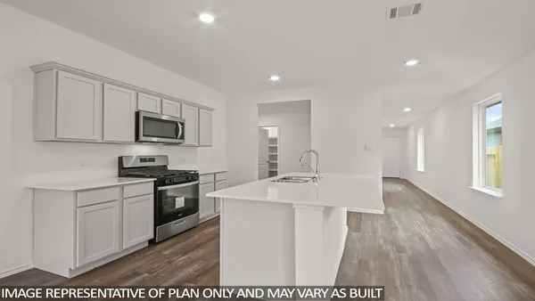a kitchen with stainless steel appliances kitchen island granite countertop a sink stove and refrigerator
