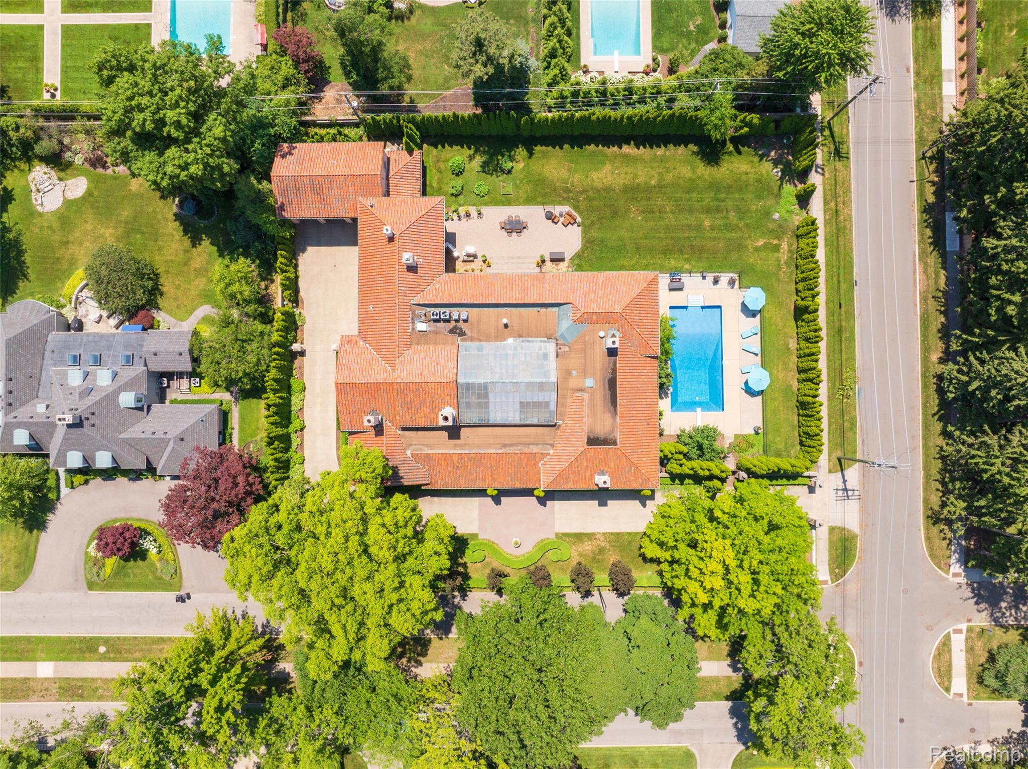 189 Cloverly Road Grosse Pointe, MI 48236 - Photo 3 of 93 The architecture revealed. This aerial perspective highlights one of the estate’s defining features: a dramatic central atrium around which the home is thoughtfully organized. Set on a rare double lot, the property combines expansive grounds, a private pool, and exceptional outdoor living with an architectural layout that is as functional as it is beautiful.