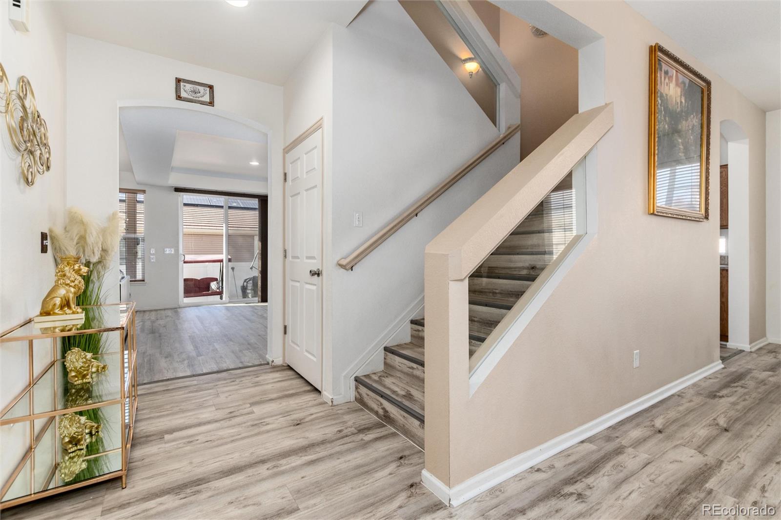 5293 Malaya Street Denver, CO 80249 - Photo 16 of 44 a view of entryway and hall with wooden floor
