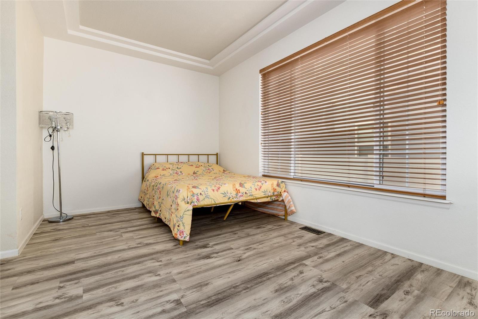 5293 Malaya Street Denver, CO 80249 - Photo 21 of 44 a room with a bed table and a window