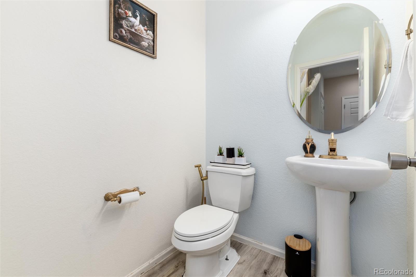 5293 Malaya Street Denver, CO 80249 - Photo 22 of 44 a bathroom with a toilet sink and mirror