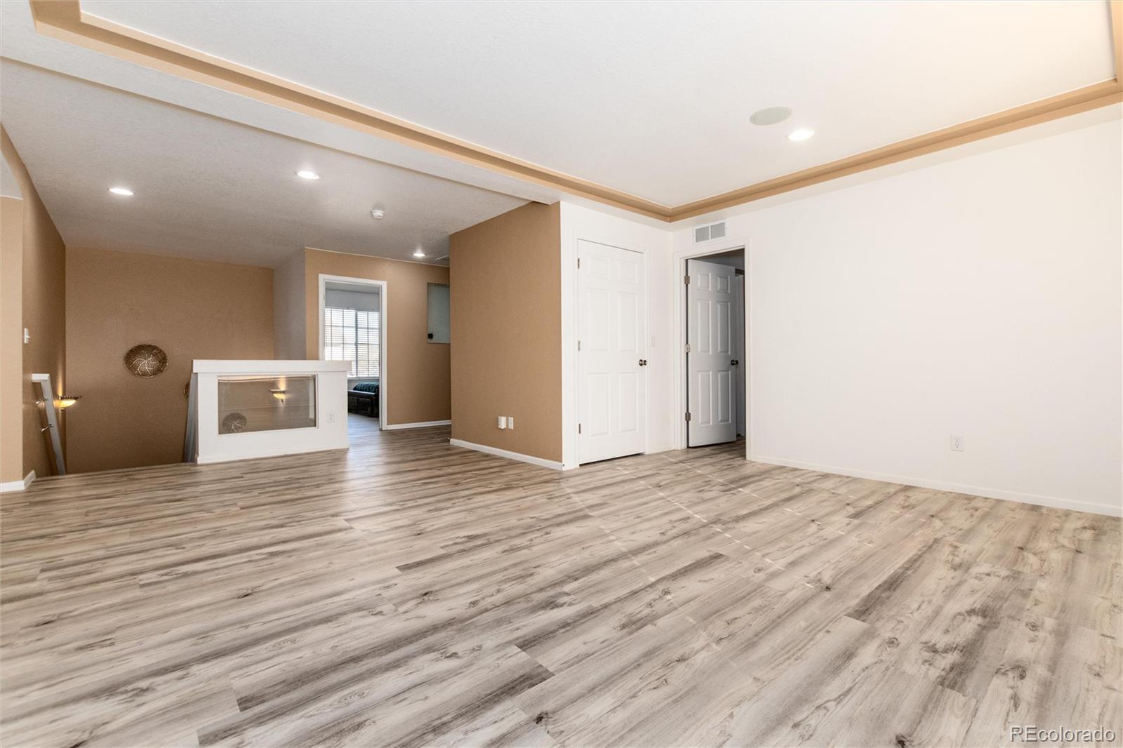 5293 Malaya Street Denver, CO 80249 - Photo 25 of 44 a view of empty room with wooden floor