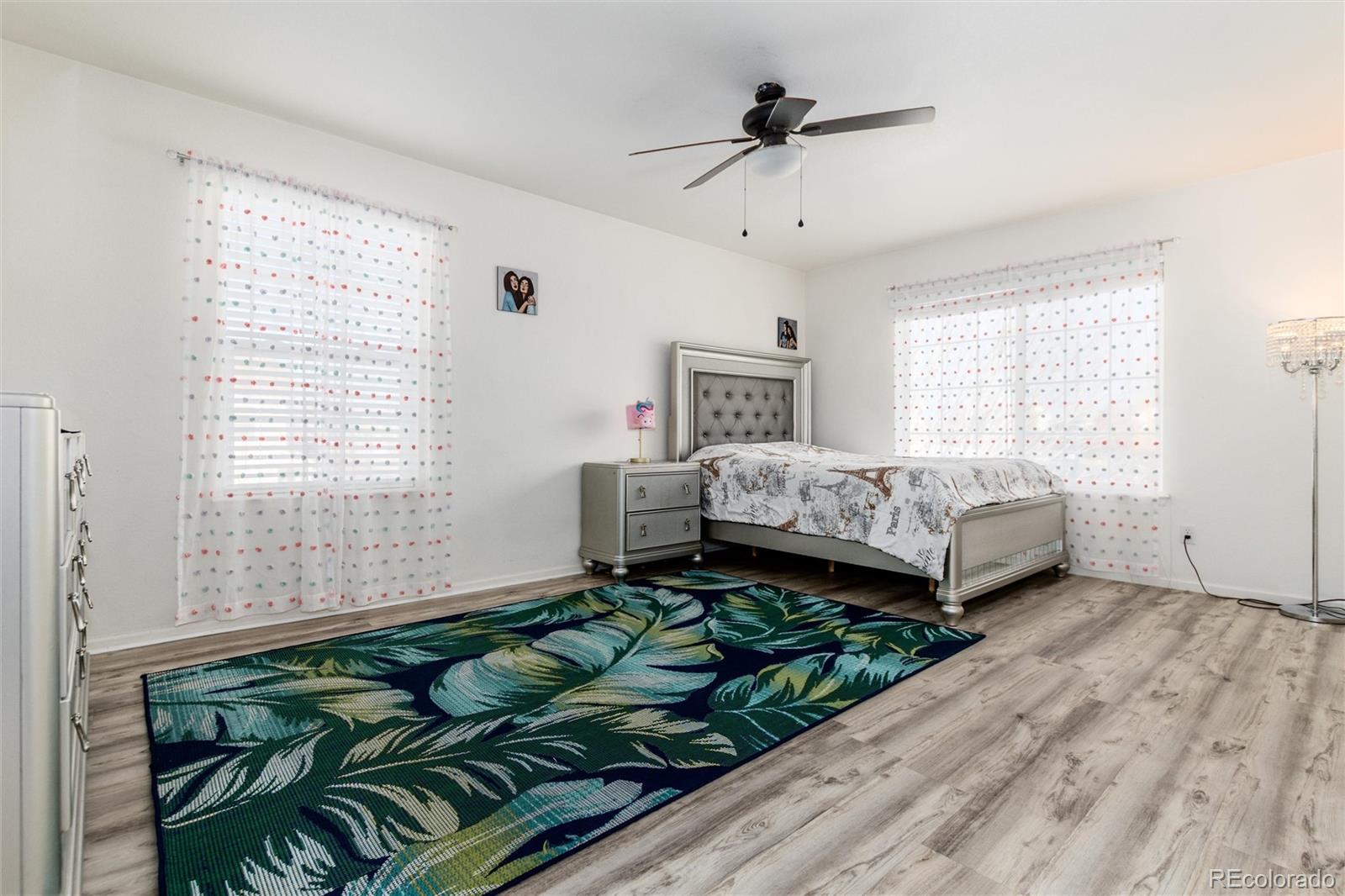5293 Malaya Street Denver, CO 80249 - Photo 27 of 44 a bedroom with a bed window and couch