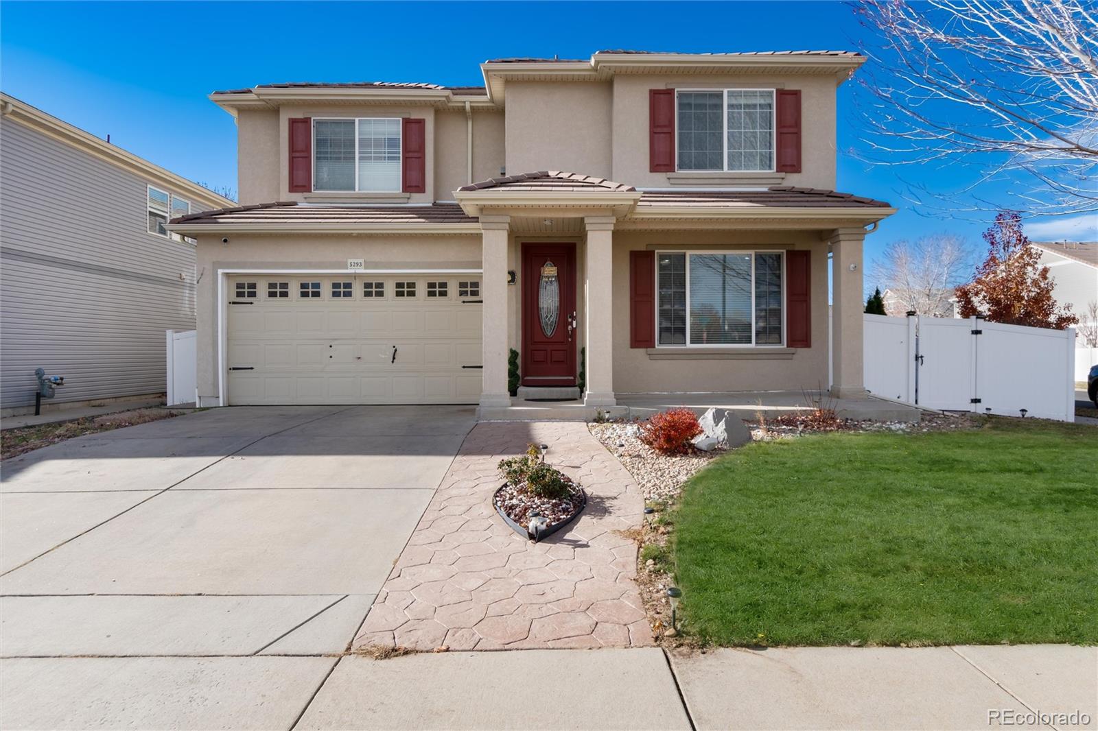 5293 Malaya Street Denver, CO 80249 - Photo 3 of 44 a front view of a house with garden