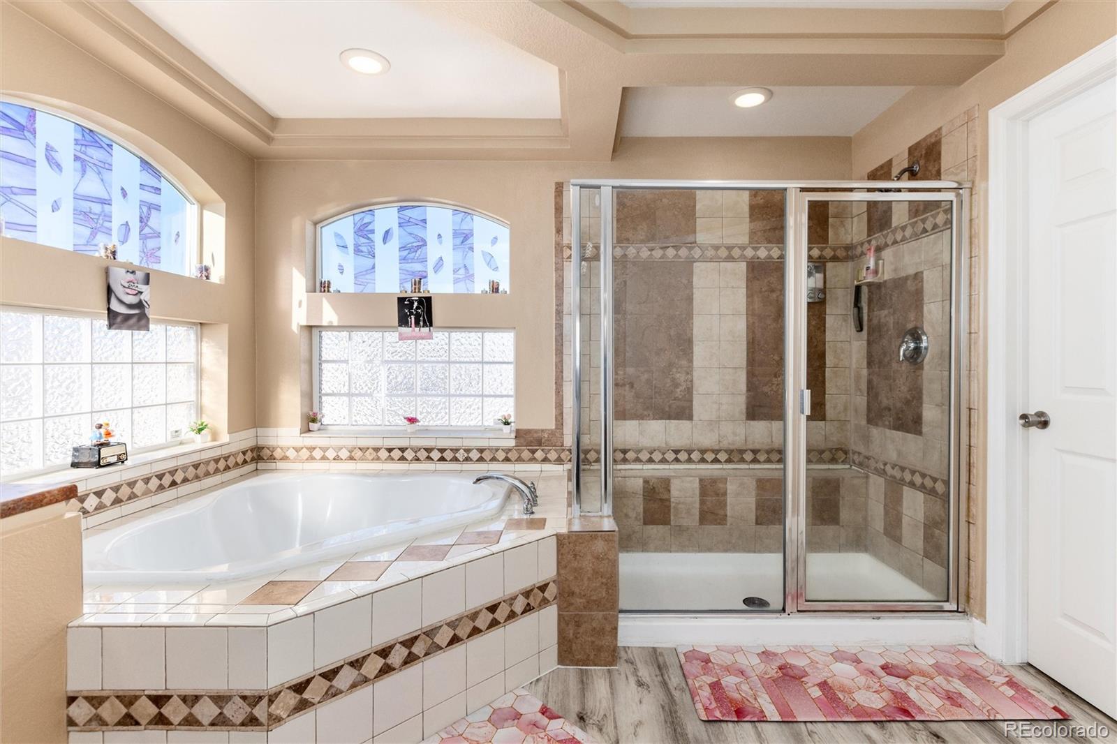 5293 Malaya Street Denver, CO 80249 - Photo 32 of 44 a bathroom with a tub and shower