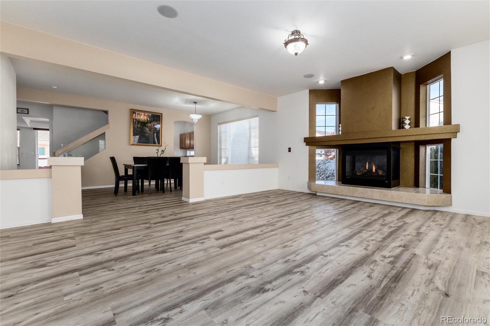 5293 Malaya Street Denver, CO 80249 - Photo 8 of 44 a view of kitchen with furniture and wooden floor