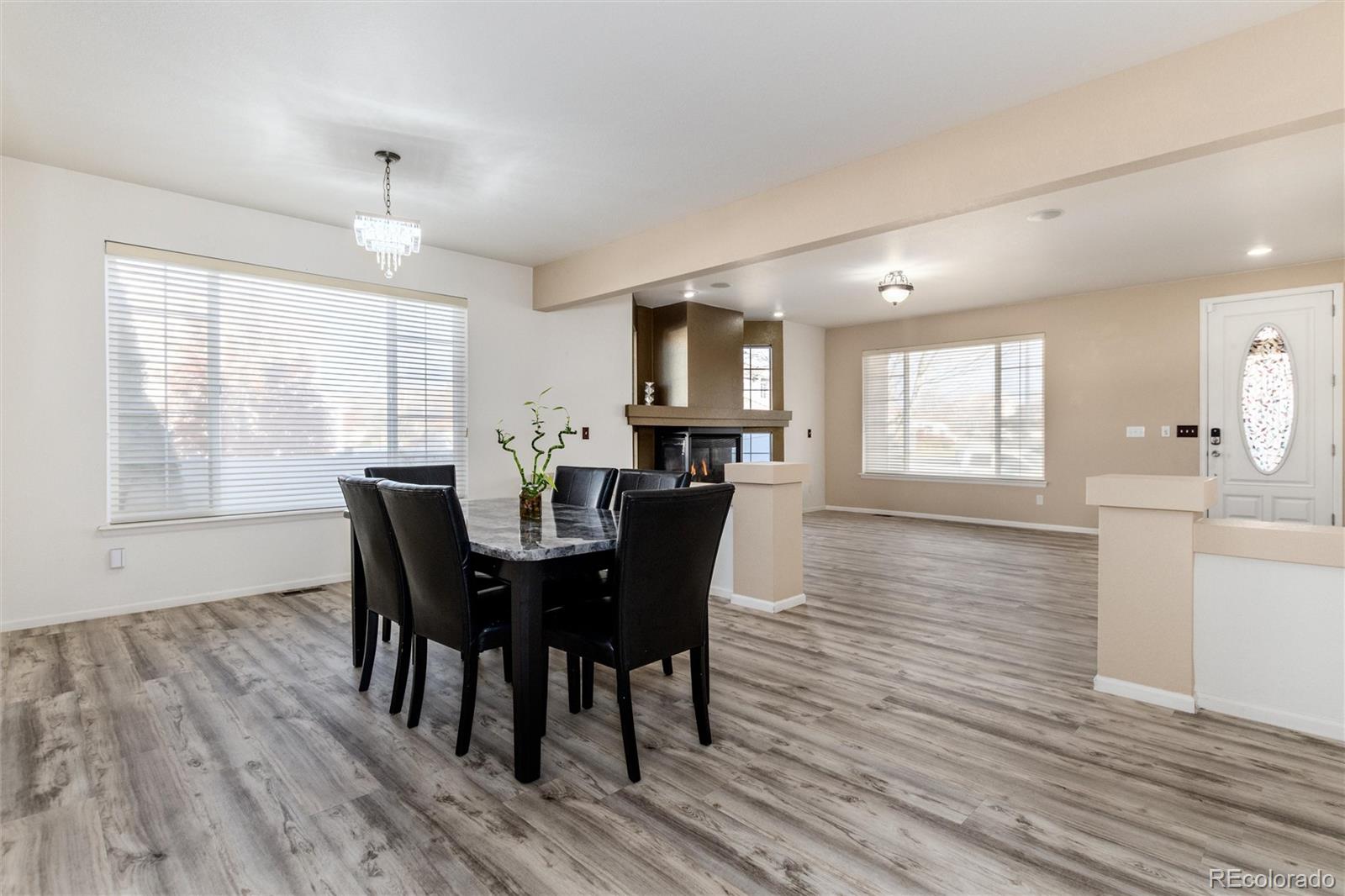 5293 Malaya Street Denver, CO 80249 - Photo 9 of 44 a view of a dining room with furniture and wooden floor