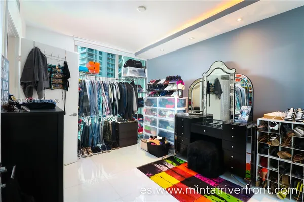 a very nice looking room with clothes and shoes
