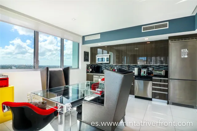 a living room with furniture and a floor to ceiling window