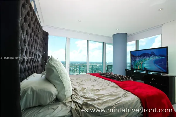 a bed sitting in a bedroom next to a window