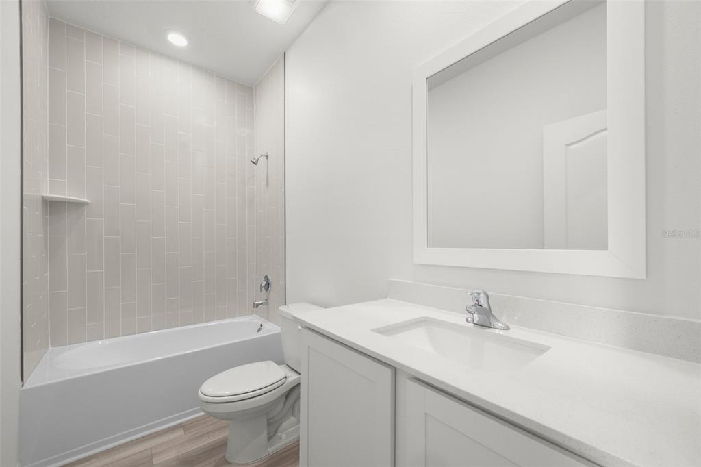 13438 Leaping Water Way Astatula, FL 34705 - Photo 16 of 18 a bathroom with a sink a toilet and shower