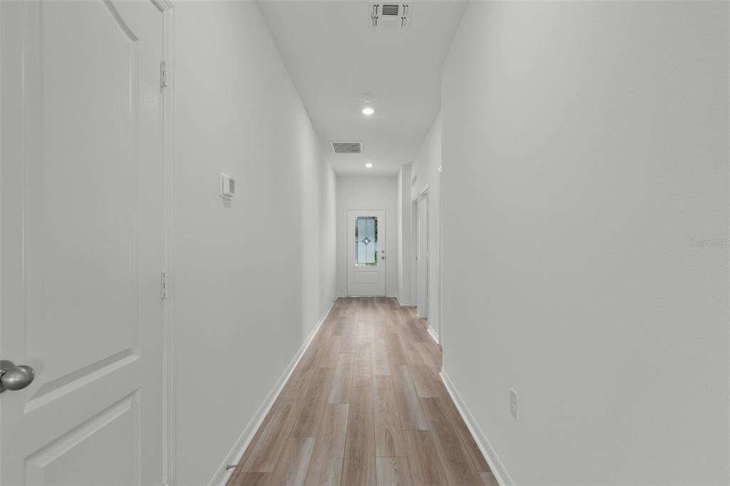13438 Leaping Water Way Astatula, FL 34705 - Photo 9 of 18 a view of a hallway with wooden floor