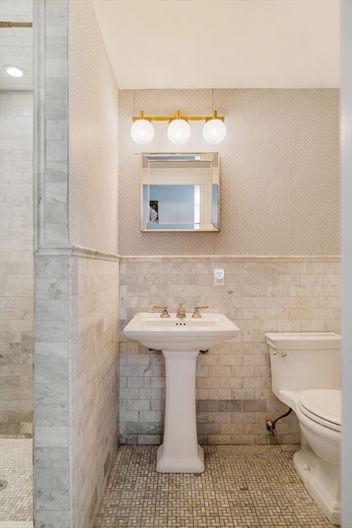 70 Oxford Street Somerville, MA 02143 - Photo 30 of 38 a bathroom with a sink a toilet and mirror