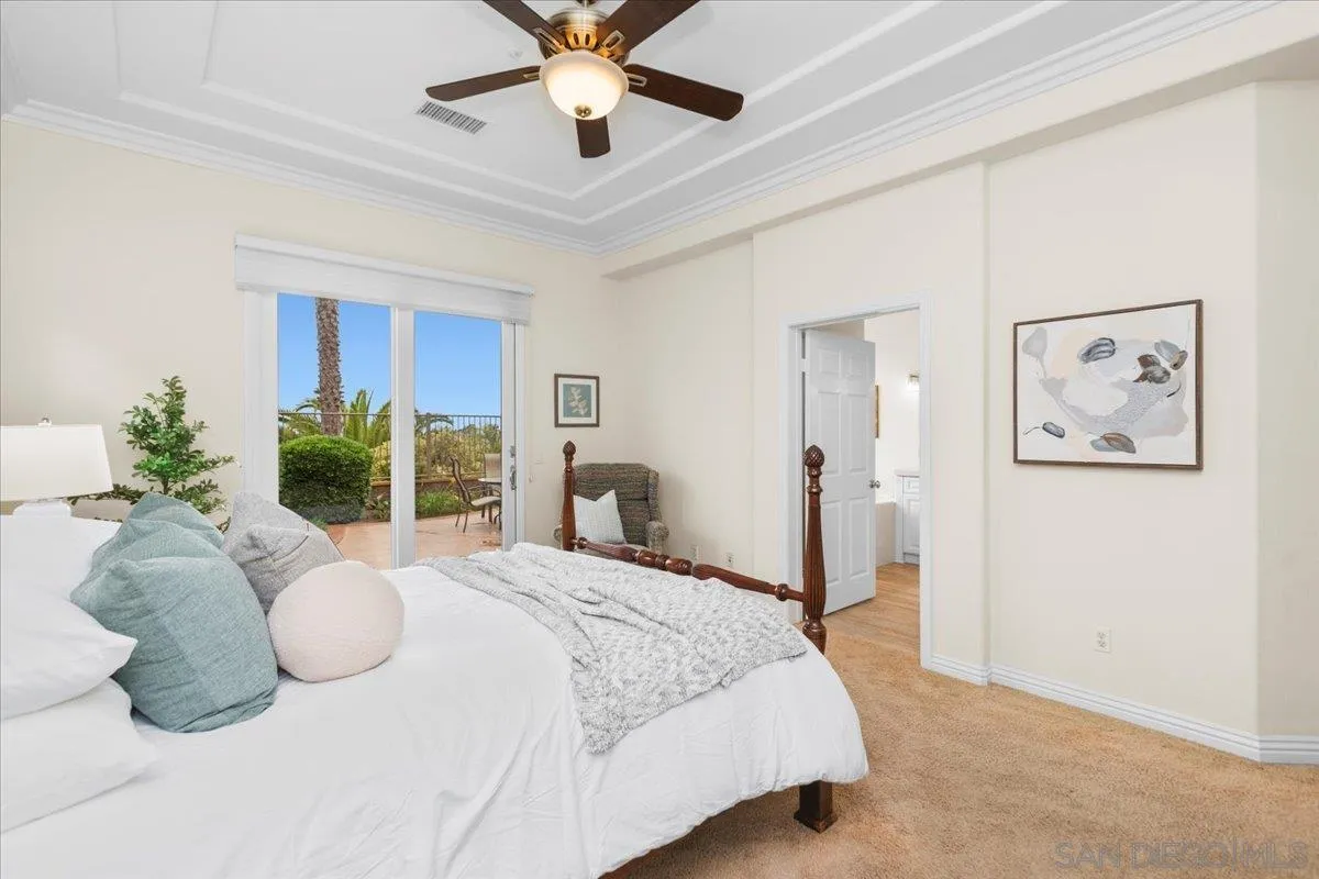 622 Brae Mar Court Encinitas, CA 92024 - Photo 15 of 24 a bedroom with a large bed and a chandelier