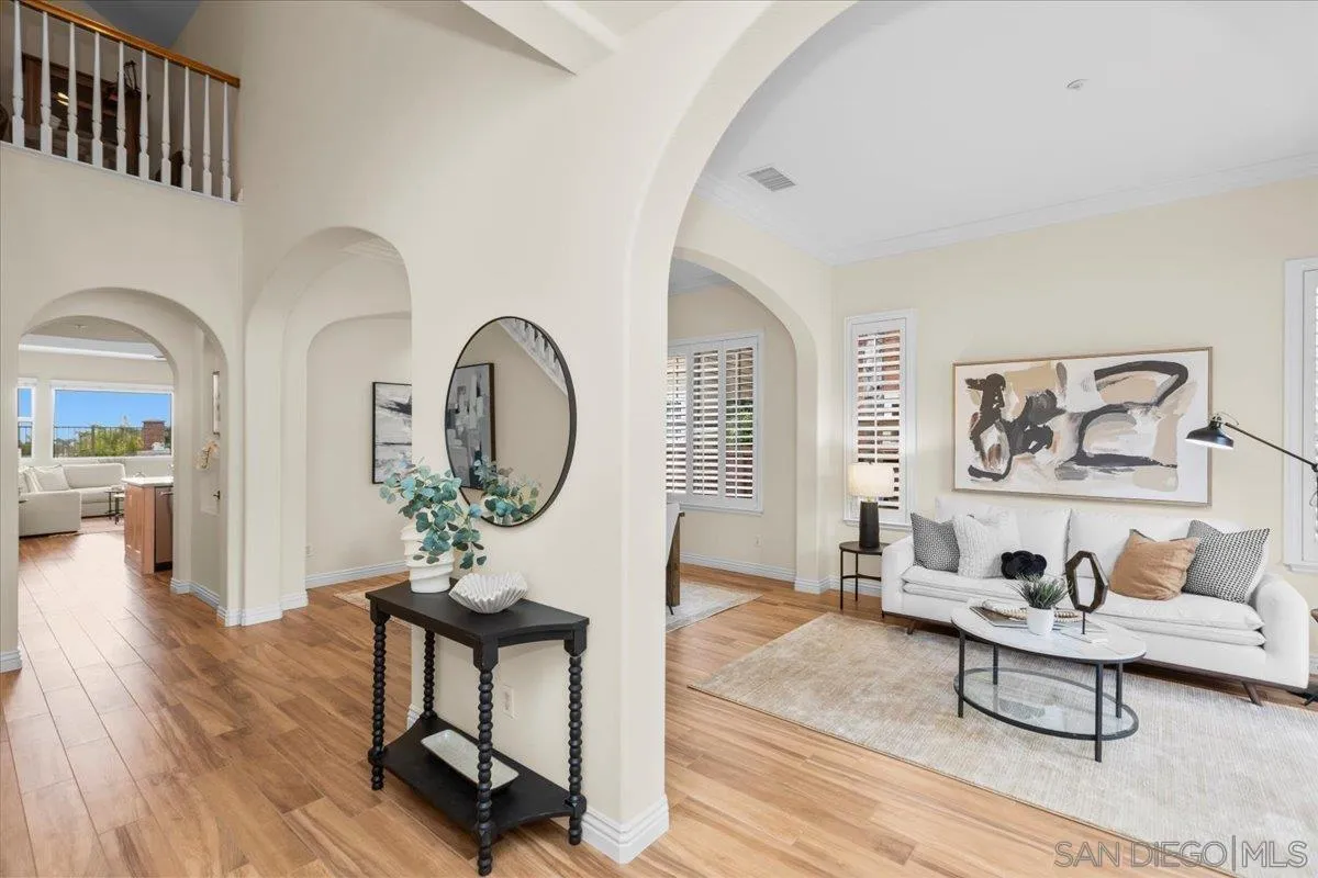 622 Brae Mar Court Encinitas, CA 92024 - Photo 4 of 24 a living room with furniture a mirror and a wooden floor