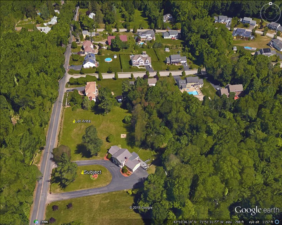 an aerial view of a residential houses with outdoor space