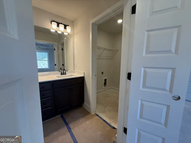 a bathroom with a sink double vanity and a mirror