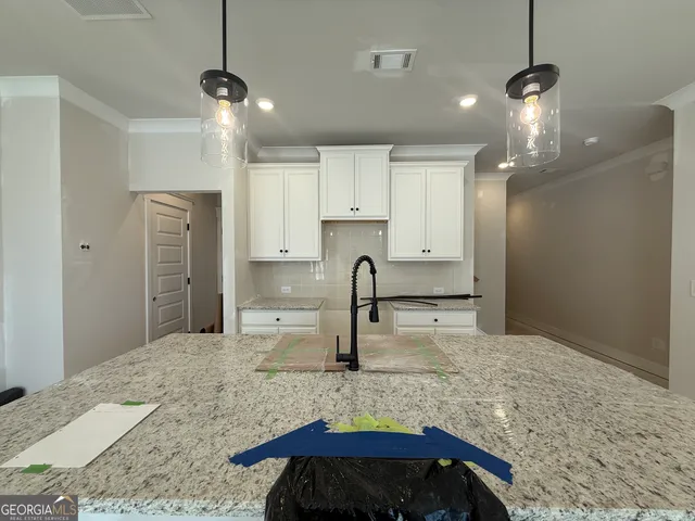 a large kitchen with kitchen island a sink stainless steel appliances and cabinets