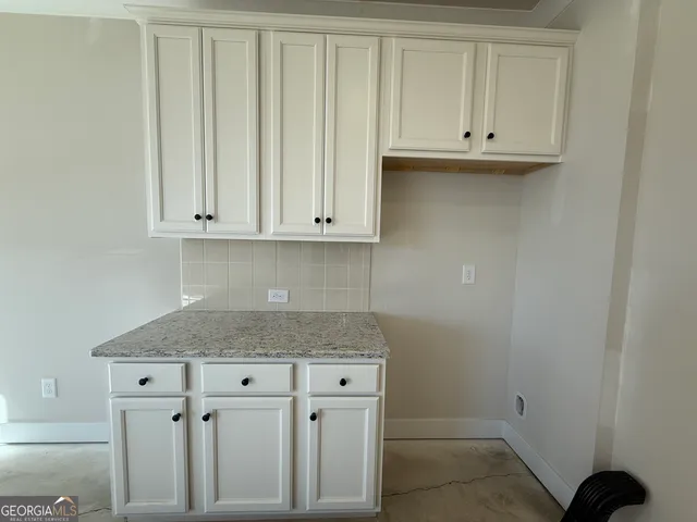 a view of cabinets and washer dryer