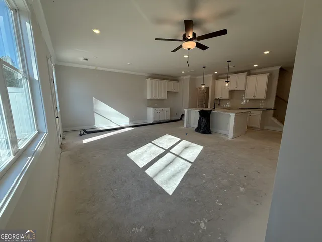 a view of a kitchen with a sink stainless steel appliances and cabinets