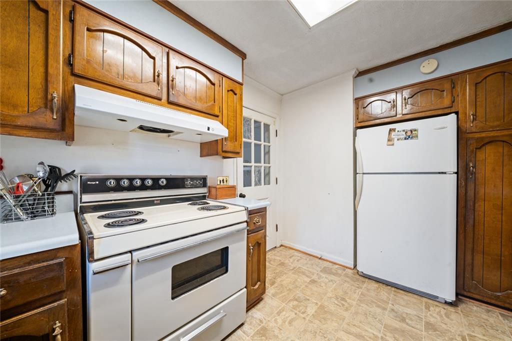 2980 Highway 46 Soperton, GA 30457 - Photo 16 of 27 a kitchen with stainless steel appliances granite countertop a stove a refrigerator and a refrigerator