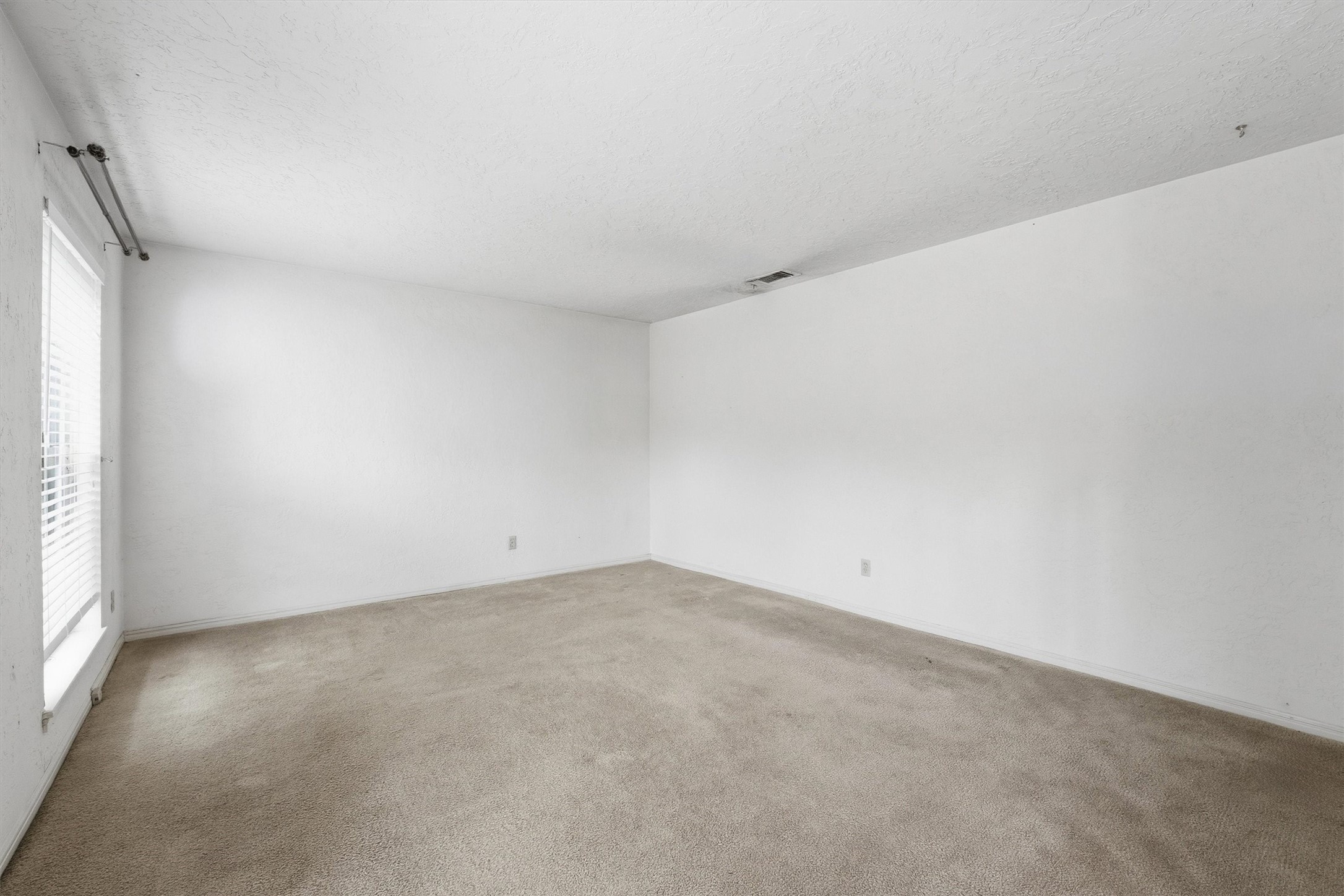 8115 Theisswood Road Spring, TX 77379 - Photo 7 of 36 an empty room with a natural light