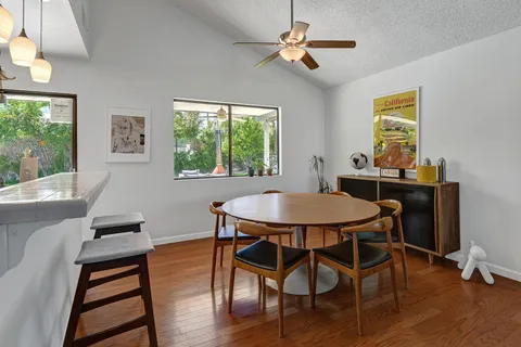 a view of a dining room with furniture window and wooden floor