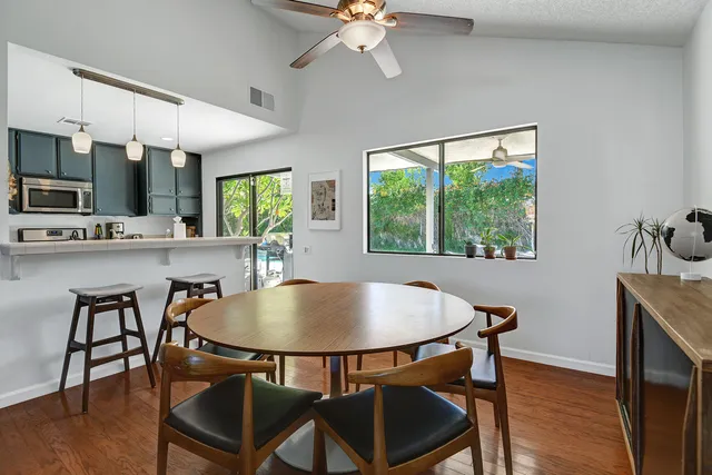 a dining room with furniture window and wooden floor