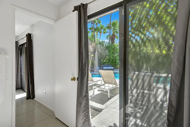 a bathroom with a double vanity sink toilet mirror and bathtub