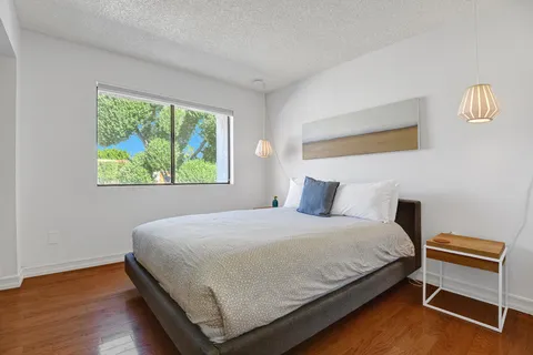 a bedroom with a bed and a window