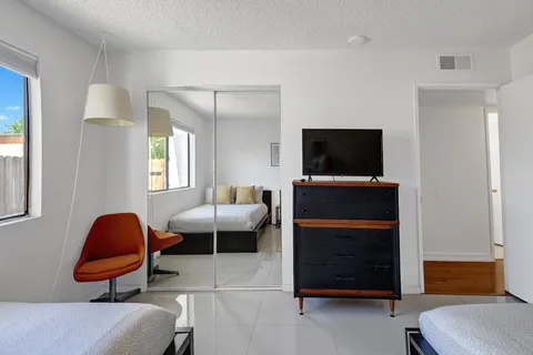 a bathroom with a sink toilet vanity and shower