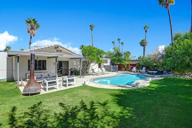 a view of a patio with a table chairs and a backyard