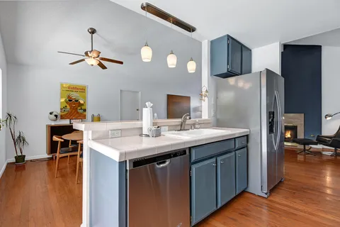 a kitchen with sink cabinets and wooden floor