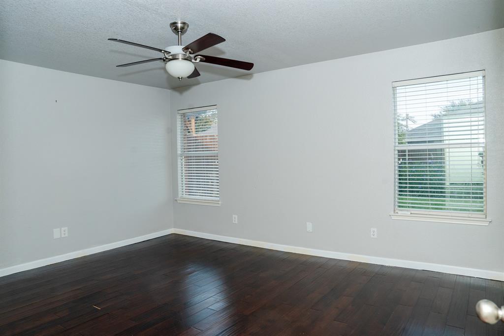 2129 Bliss Road Fort Worth, TX 76177 - Photo 16 of 22 a view of an empty room with wooden floor and a window