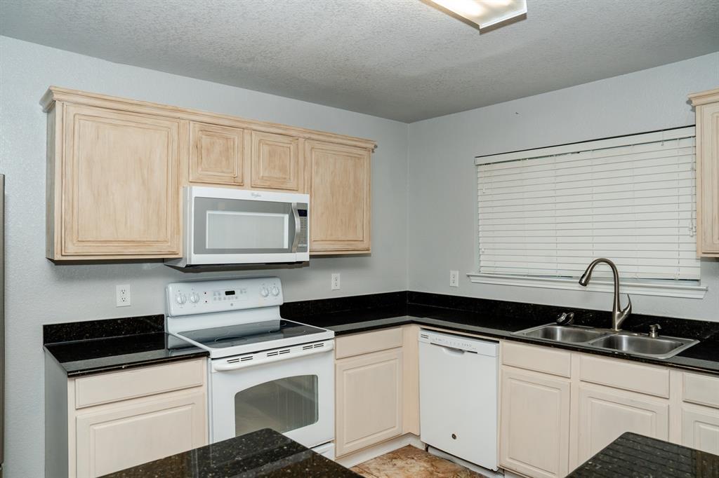 2129 Bliss Road Fort Worth, TX 76177 - Photo 6 of 22 a kitchen with granite countertop white cabinets and white appliances