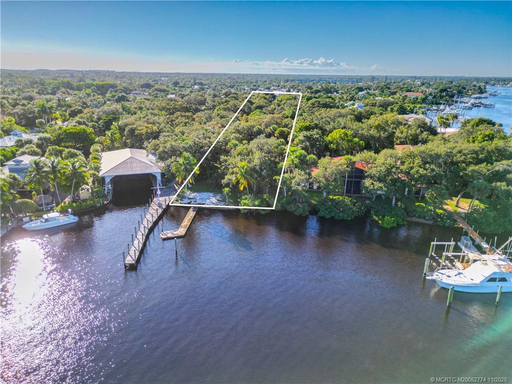 4605 Southeast Williams Way Stuart, FL 34997 - Photo 1 of 7 an aerial view of a house with a yard