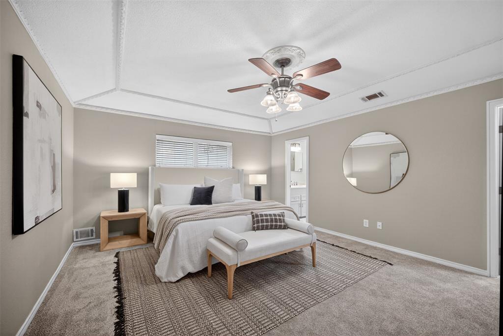 9660 Timberleaf Drive Dallas, TX 75243 - Photo 28 of 40 Recessed ceiling with decorative molding, ceiling fan with light fixture, carpeted flooring, window with white blinds, and an entryway into a bathroom