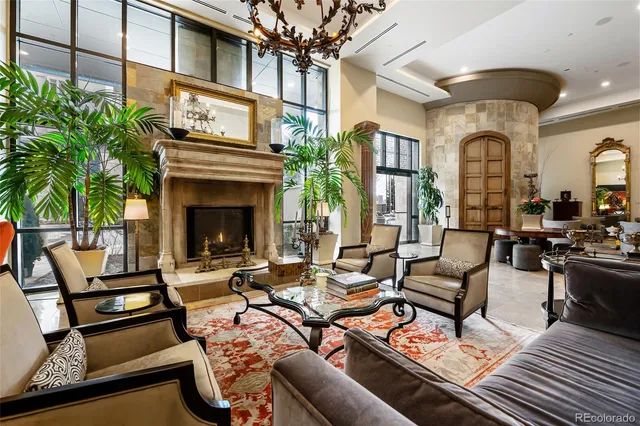 a living room with furniture a fireplace and a potted plant