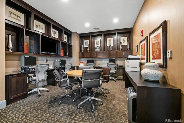 a view of a dining room with furniture a rug and a flat screen tv