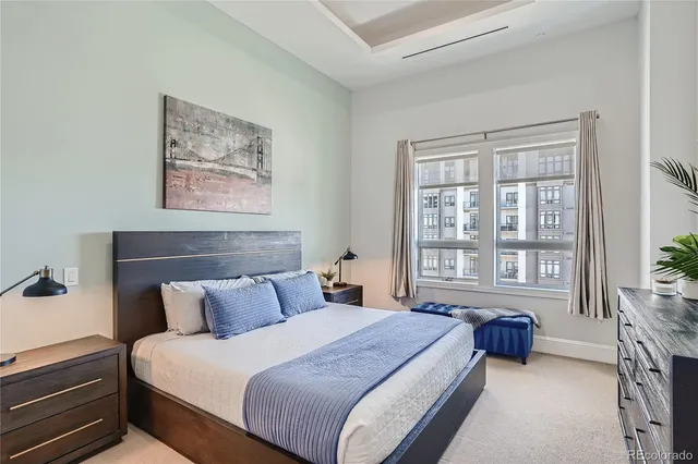 a bedroom with bed and a large window