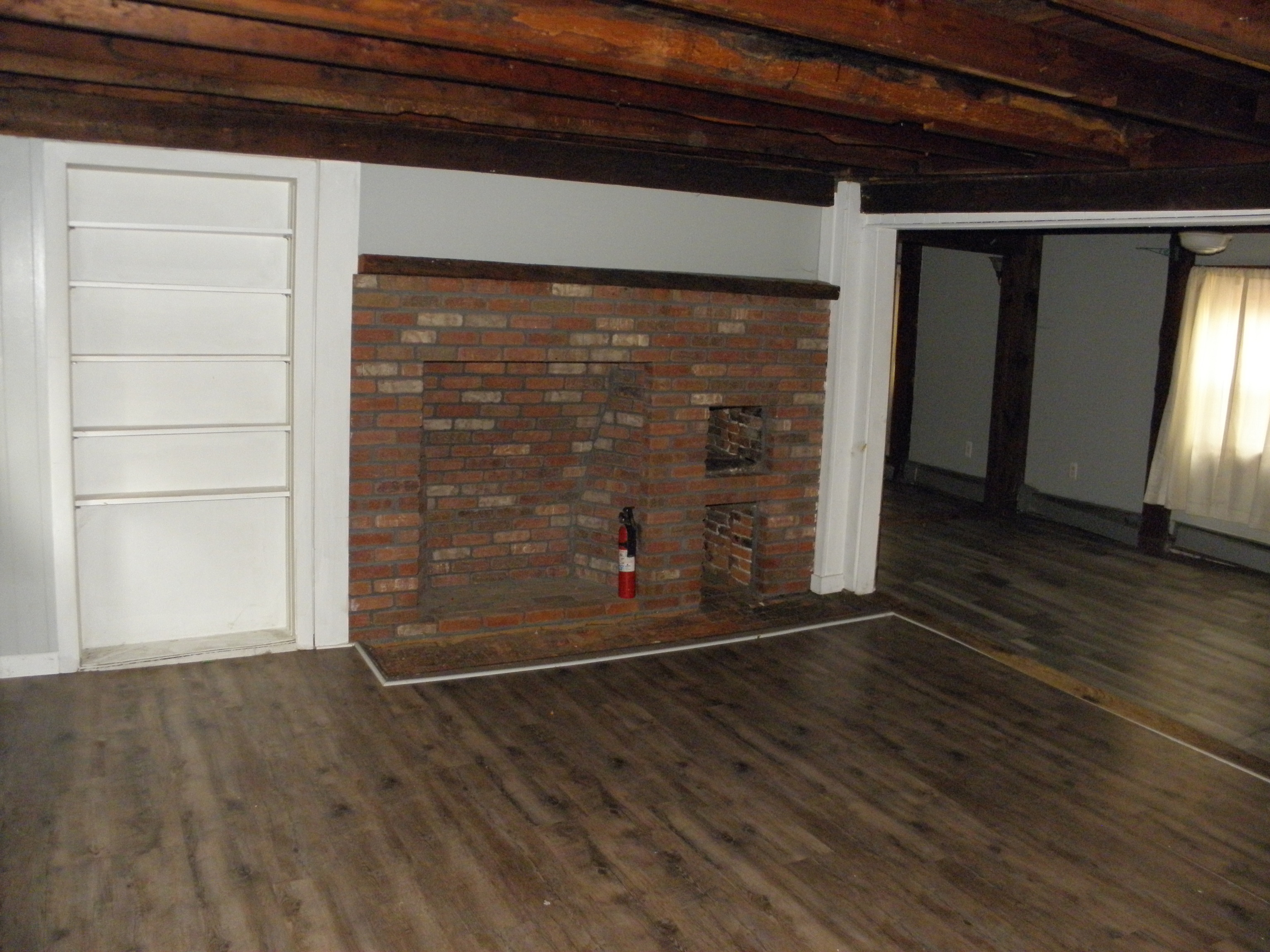 29 Union Street Plainfield, CT 06354 - Photo 7 of 12 an empty room with wooden floor and windows