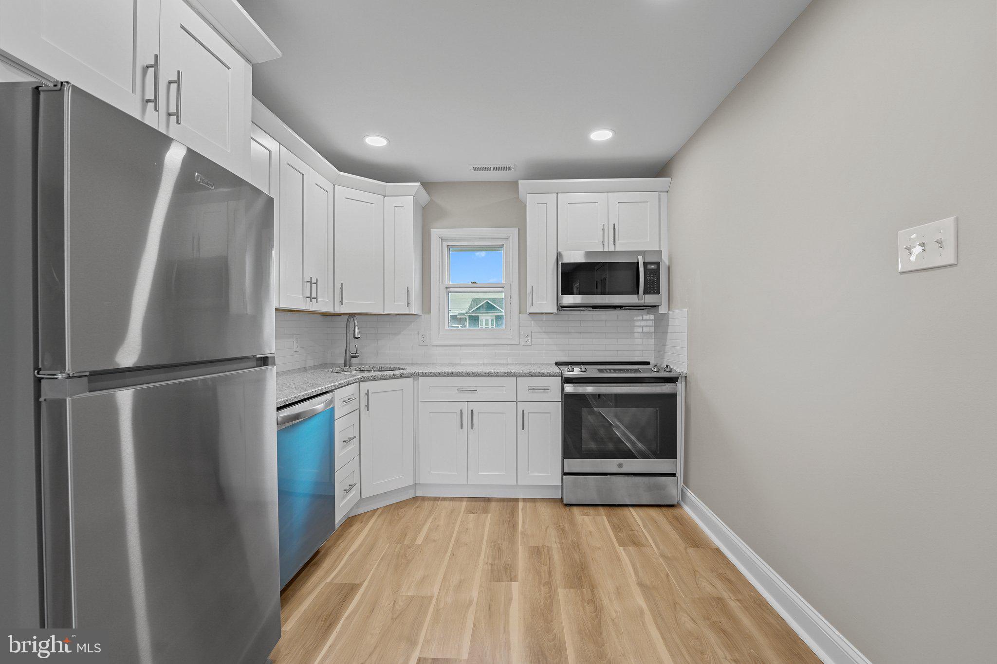 16 Granite Road Levittown, PA 19057 - Photo 5 of 27 a kitchen with a refrigerator stove and microwave