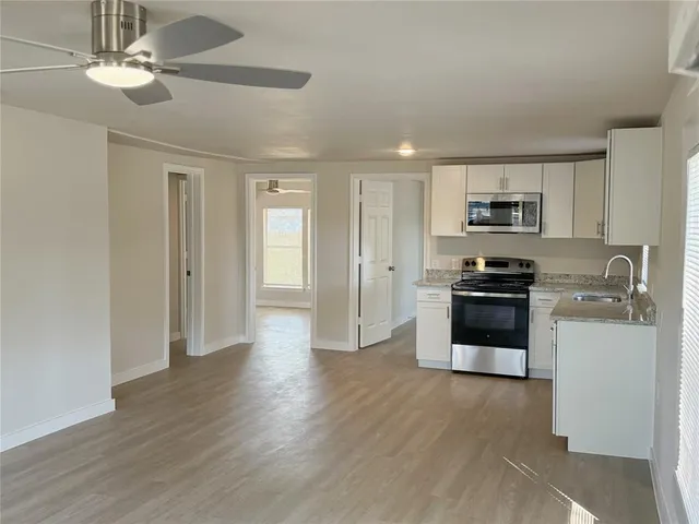 a kitchen with stainless steel appliances a refrigerator sink and stove