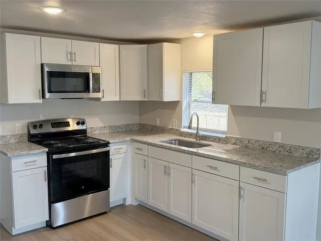 a kitchen with appliances cabinets and a sink