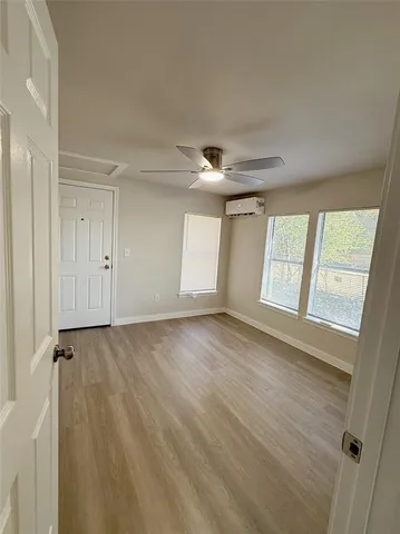 a view of an empty room and a window