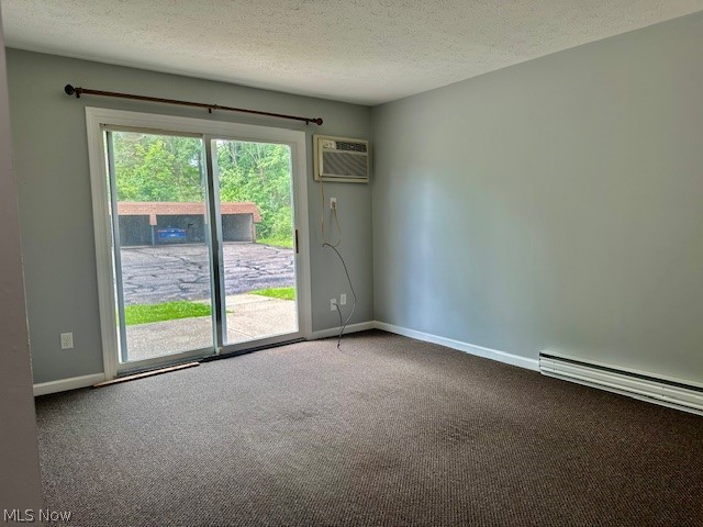 4376 Darrow Road, Unit 2 Stow, OH 44224 - Photo 3 of 26 Carpeted spare room with a wall mounted air conditioner, baseboards, baseboard heating, and a textured ceiling